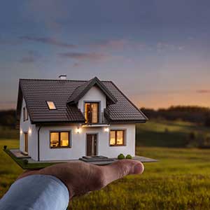 Housing Counselors hand holding a miniature house